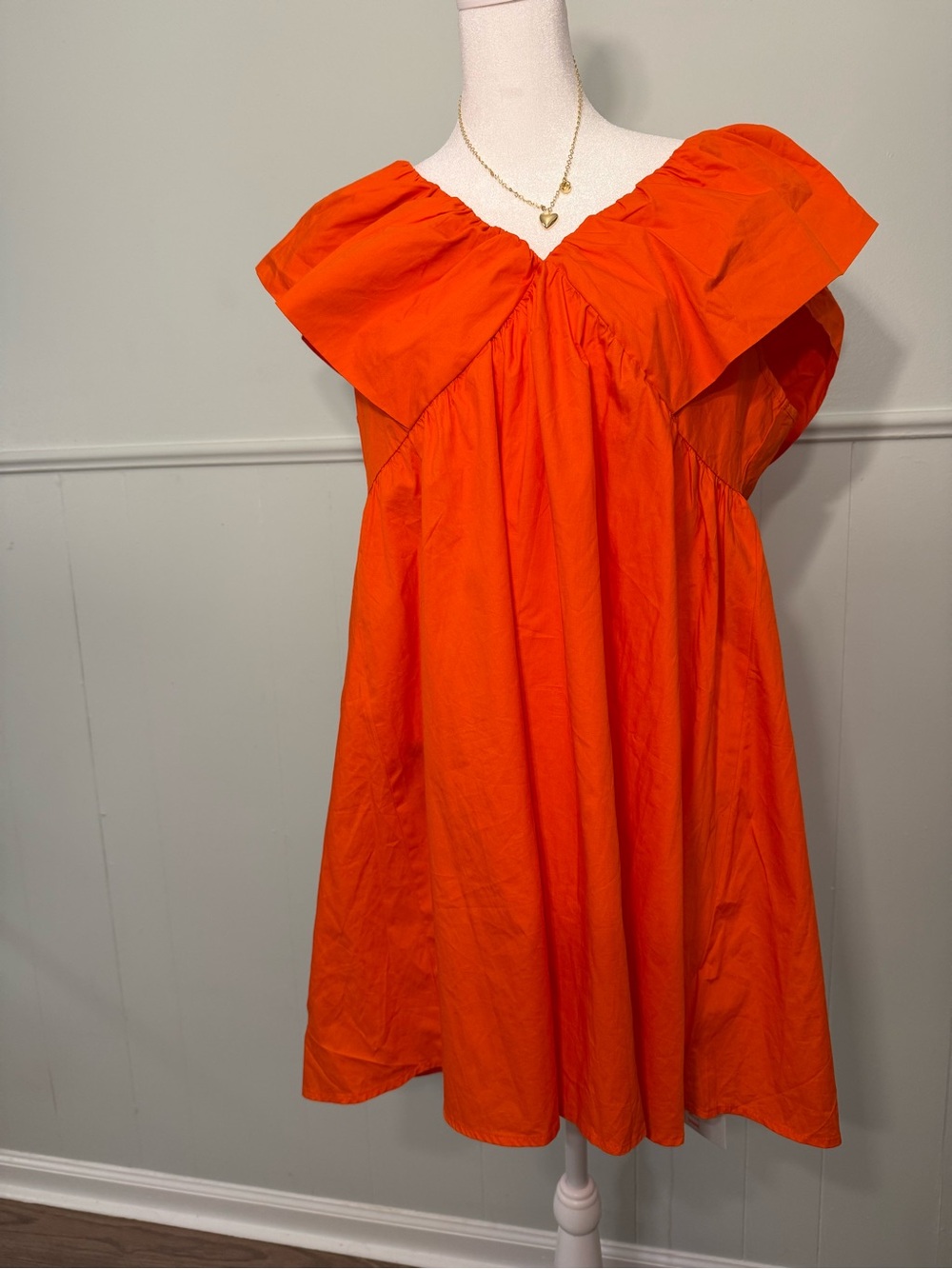 Orange V-neck dress with ruffles, size M